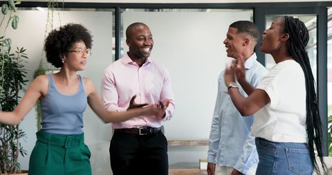 Diverse Team Celebrating Success in Casual Office Setting