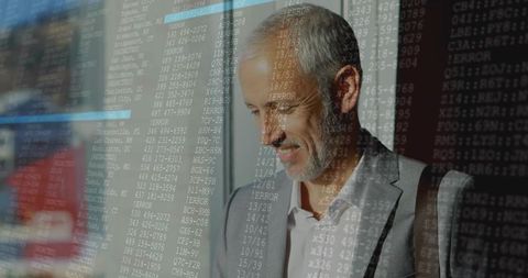 Businessman engaging with code overlay on glass office walls