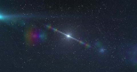 Iridescent meteor streaking through starfield with rainbow halo and lens flares