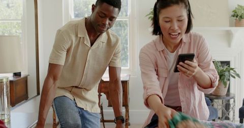 Diverse Friends Laughing at Home Collaborating on Activity