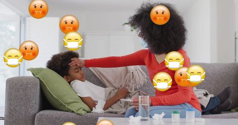 Mother Caring for Ill Son on Couch with Floating Emojis