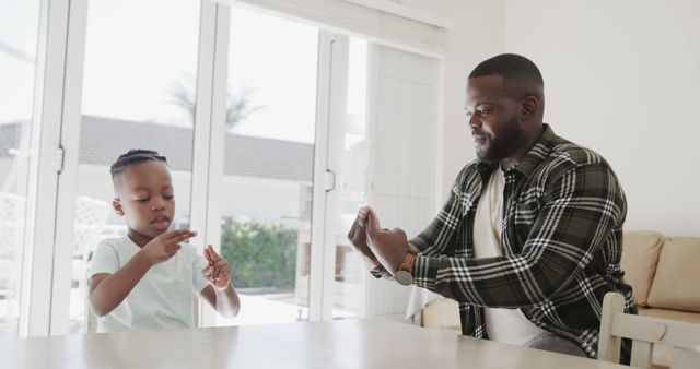 Father and Son Learning Sign Language Together at Home - Download Free Stock Images Pikwizard.com