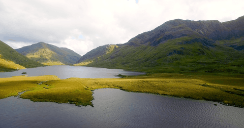 transparent mountain lake scene with clear sky reflection - Download Free Stock Videos Pikwizard.com