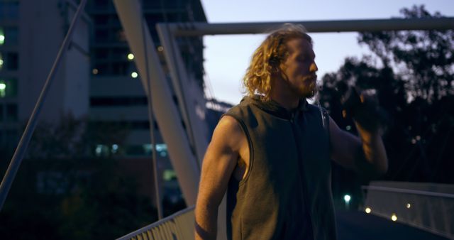 Man Drinking Water While Jogging on Bridge at Dusk - Download Free Stock Images Pikwizard.com