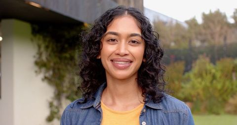 Smiling Woman in Garden Setting Outdoors