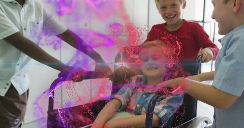 School children pushing classmate in wheelchair through sunlit hall inclusive teamwork