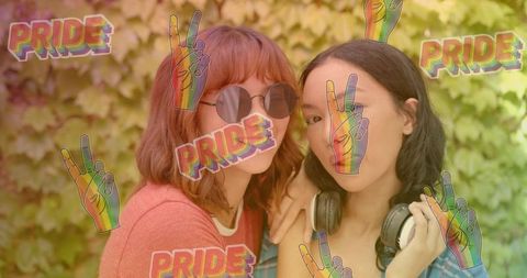 Young queer friends posing with rainbow pride stickers in sunlit backyard garden