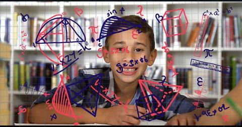 Smiling schoolboy studying with colorful geometry sketches overlaying library shelves