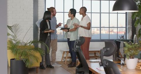 Diverse Business Team Collaborating Digitally in Modern Office