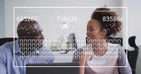 Colleagues Collaborating on Digital Data Analysis at Office Desk