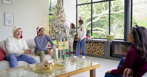 Multigenerational Family Gathering Around Christmas Tree in Modern Living Room