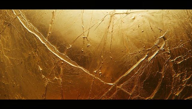 Luxurious metallic gold surface with weathered texture
