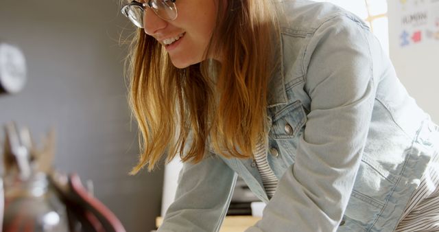 Smiling Woman Wearing Glasses Working in Creative Workspace - Download Free Stock Images Pikwizard.com