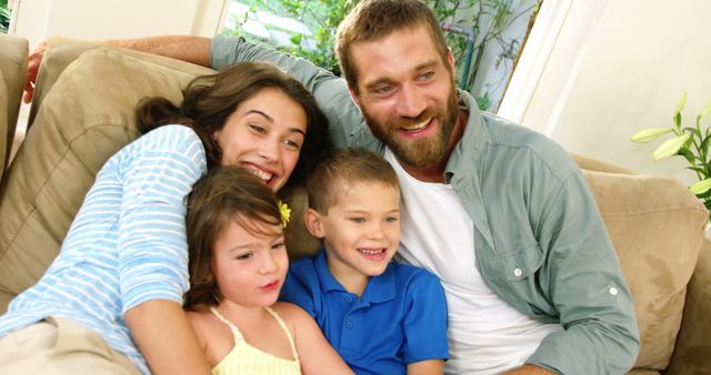 Happy Family Relaxing on Couch Together Indoors - Download Free Stock Images Pikwizard.com