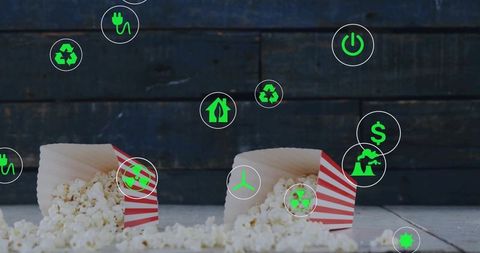 Eco-friendly concept with spilled popcorn and green energy icons