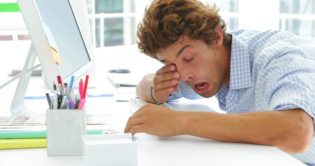 Tired Young Man Falling Asleep at Desk in Office - Download Free Stock Images Pikwizard.com