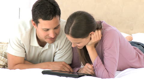 Couple Engaging with a Tablet in Relaxed Setting