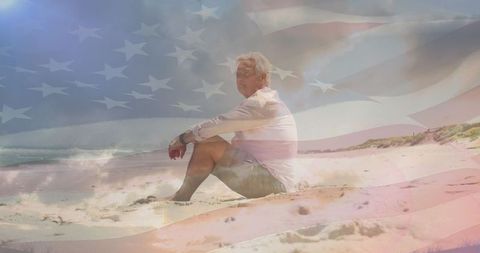 Senior Man Peacefully Reflecting on Beach Against US Flag Overlay