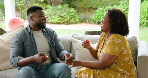 African American Couple Engaging in Cheerful Home Conversation
