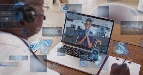 Doctor Using Laptop for Telehealth Consultation in Office