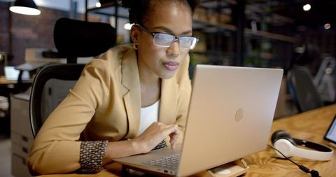 Focused African American Businesswoman Working Late in Modern Office