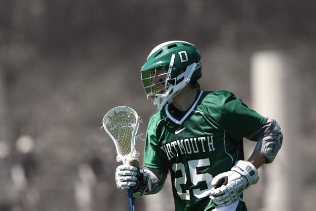 Lacrosse Player in Green Uniform Running During Game - Download Free Stock Images Pikwizard.com