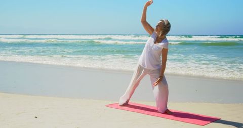 Senior Woman Practicing Yoga Stretches on Beach - Download Free Stock Images Pikwizard.com