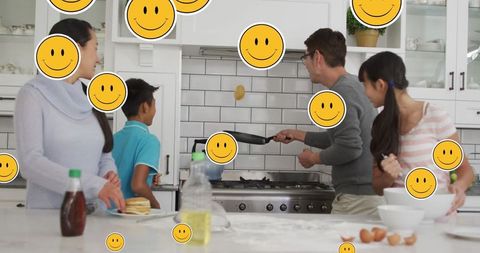 Family Cooking Together with Digital Overlay of Emoji Icons