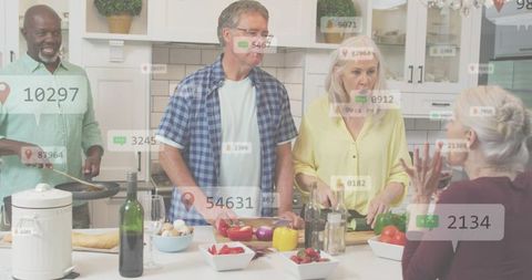 Mature friends cooking around kitchen island chopping colorful vegetables and socializing
