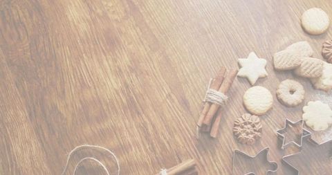 Rustic star and round cookies with cinnamon sticks, metal cutters on wood surface