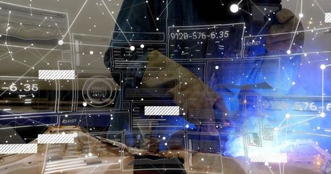 Welder Operating Torch with Augmented Reality Overlay and Gloved Hands Steadying Workpiece