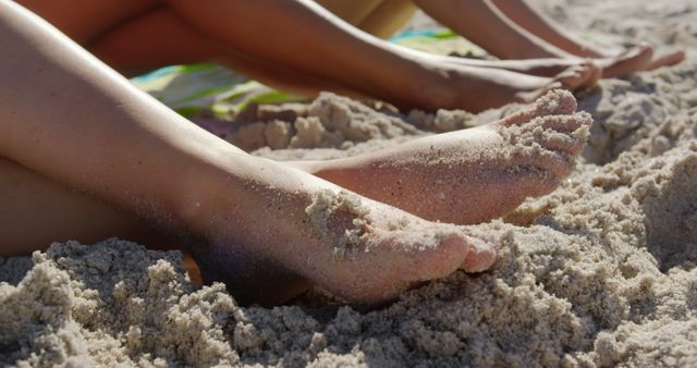 Sandy feet hint at a relaxing day at the beach. Close-up showcases a moment of leisure and connection with nature.