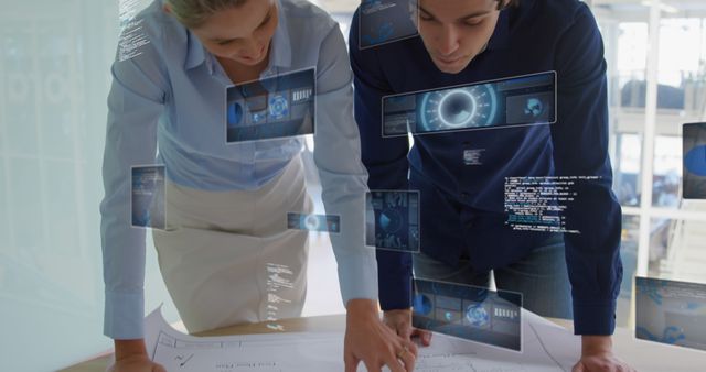 Two engineers analyzing blueprints on table with augmented reality holograms in modern office. Ideal for depicting innovation, workplace collaboration, futuristic technology in engineering, and project planning scenes. Useful for articles on advanced technology in workspace, team dynamics, and modern design processes.