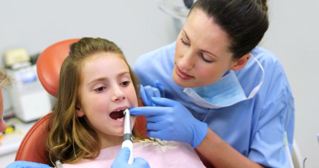 Female Dentist Examining Young Girl in Dental Office - Download Free Stock Images Pikwizard.com