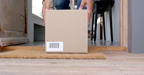 Courier delivering package to home doorstep emphasizing online shopping