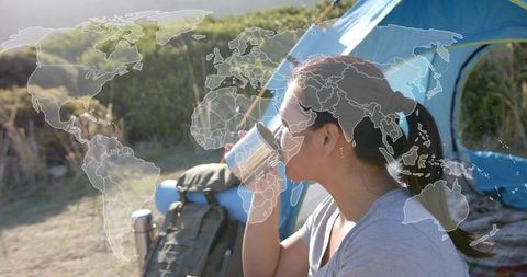 Woman Enjoying Morning Beverage at Scenic Campsite