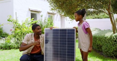 Father and daughter exploring solar panel technology together