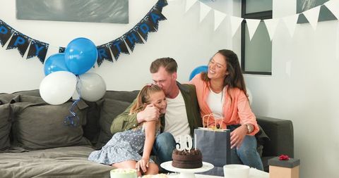 Family Birthday Celebration with Happy Father Unpacking Gifts