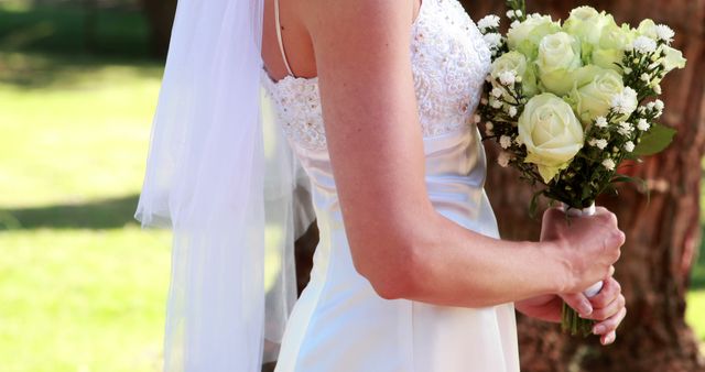 Bride holding a bouquet on a sunny day