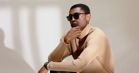 Fashionable man contemplating modern minimalist style