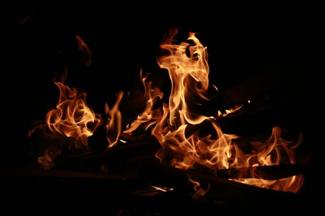 Close-up of Burning Flames in Dark Background - Download Free Stock Photos Pikwizard.com