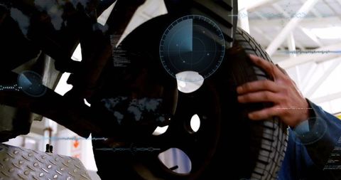 Mechanic Fitting Tire Showcasing Automotive Technology Innovations