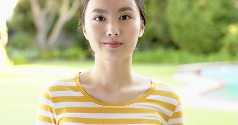 Elegant Asian Woman in Striped Top Outdoor Leisure Portrait