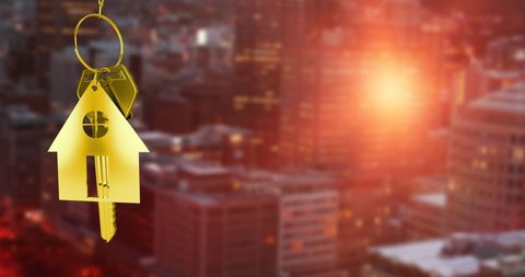 Real Estate Concept: House Keychain With City Lights Background