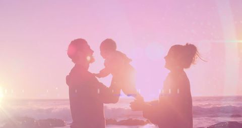 Family Enjoying Sunset with Baby at the Beach