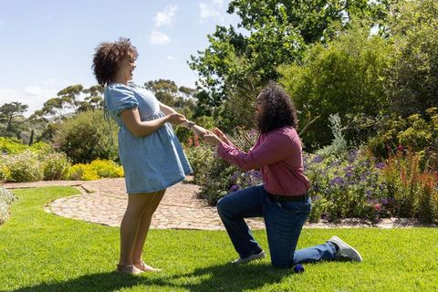Joyful Garden Proposal with Diverse Couple Sharing Happiness