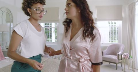 Woman comforting bride in elegant room filled with emotion