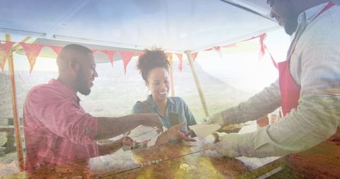 Joyful Couple Enjoying Food Vendors in Countryside Setting