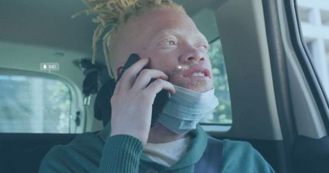 Urban Passenger Talking on Phone Wearing Face Mask in Backseat
