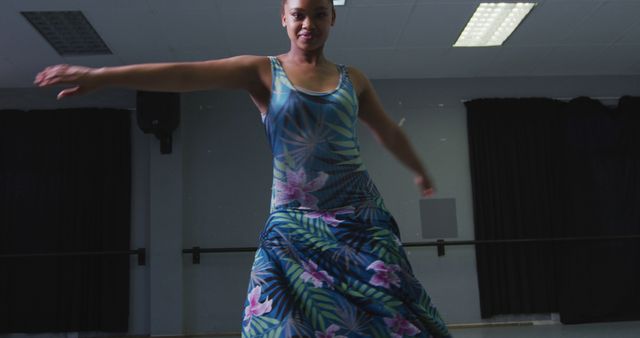 Confident Dancer Twirling in Floral Dress During Rehearsal - Download Free Stock Images Pikwizard.com